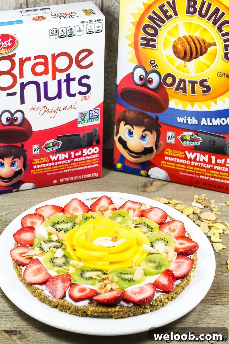 This breakfast pizza is made with a nutty cereal crust then topped with Greek yogurt and tropical fruits. It is simple, healthy and delicious!