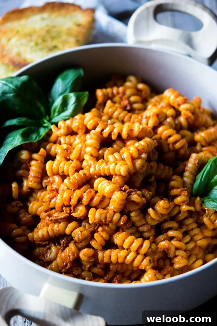 a close up of sun dried tomato pasta and basil