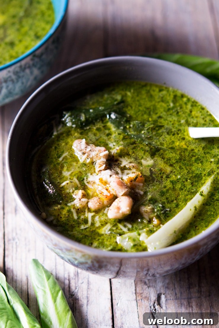 A close up of green soup made with pesto and cannellini beans