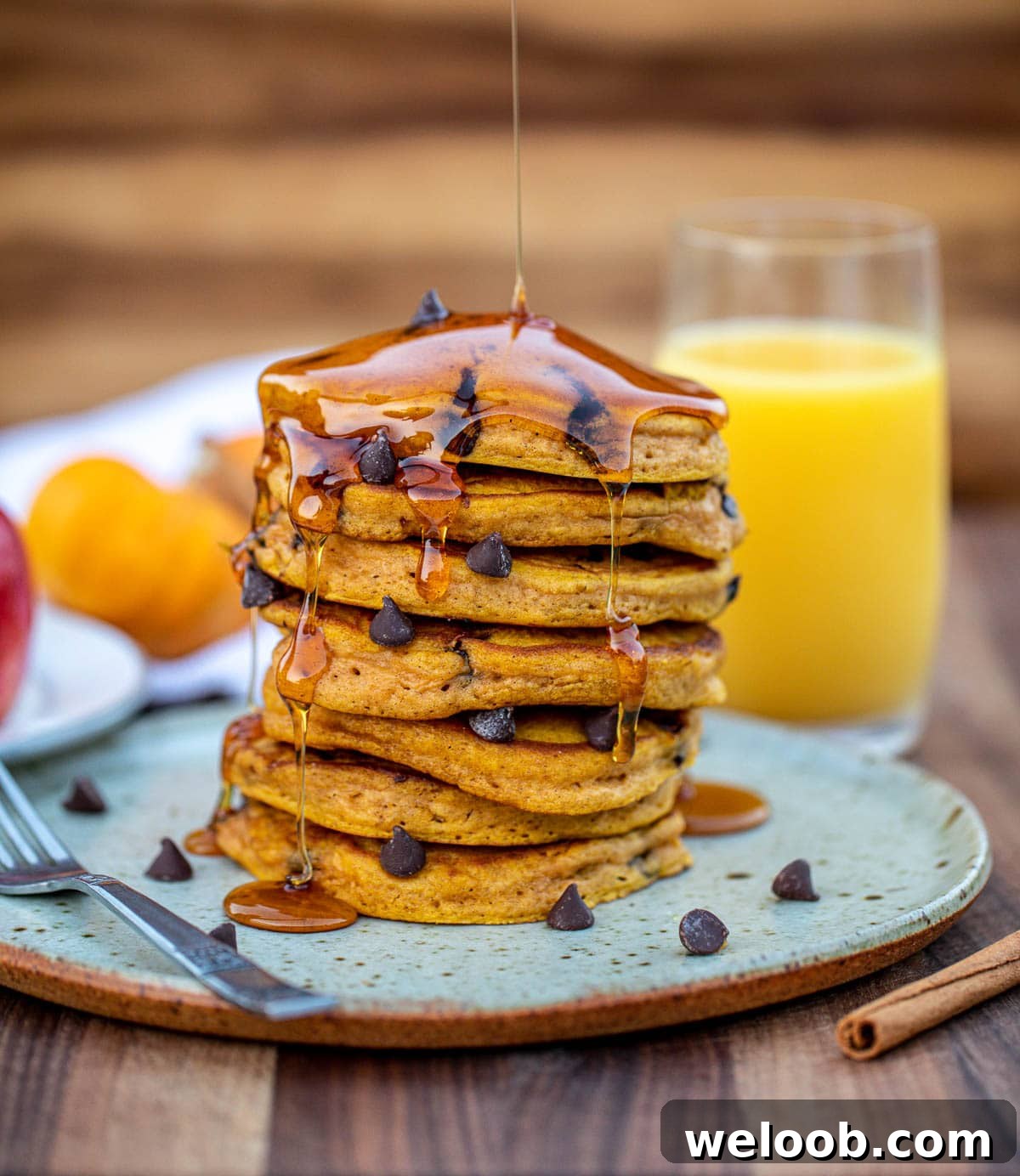 Stack of pumpkin chocolate chip pancakes on a plate.