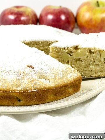 Apple cake with a slice being removed.