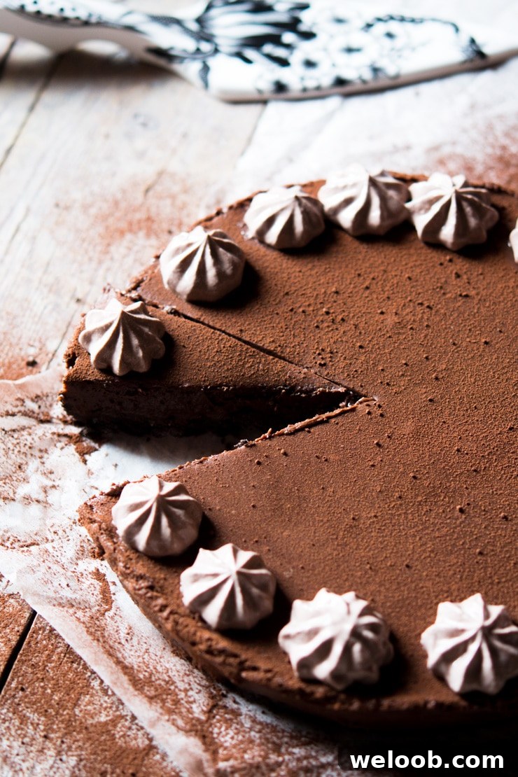 a slice of no bake chocolate cheesecake cut out and sitting on a wooden surface