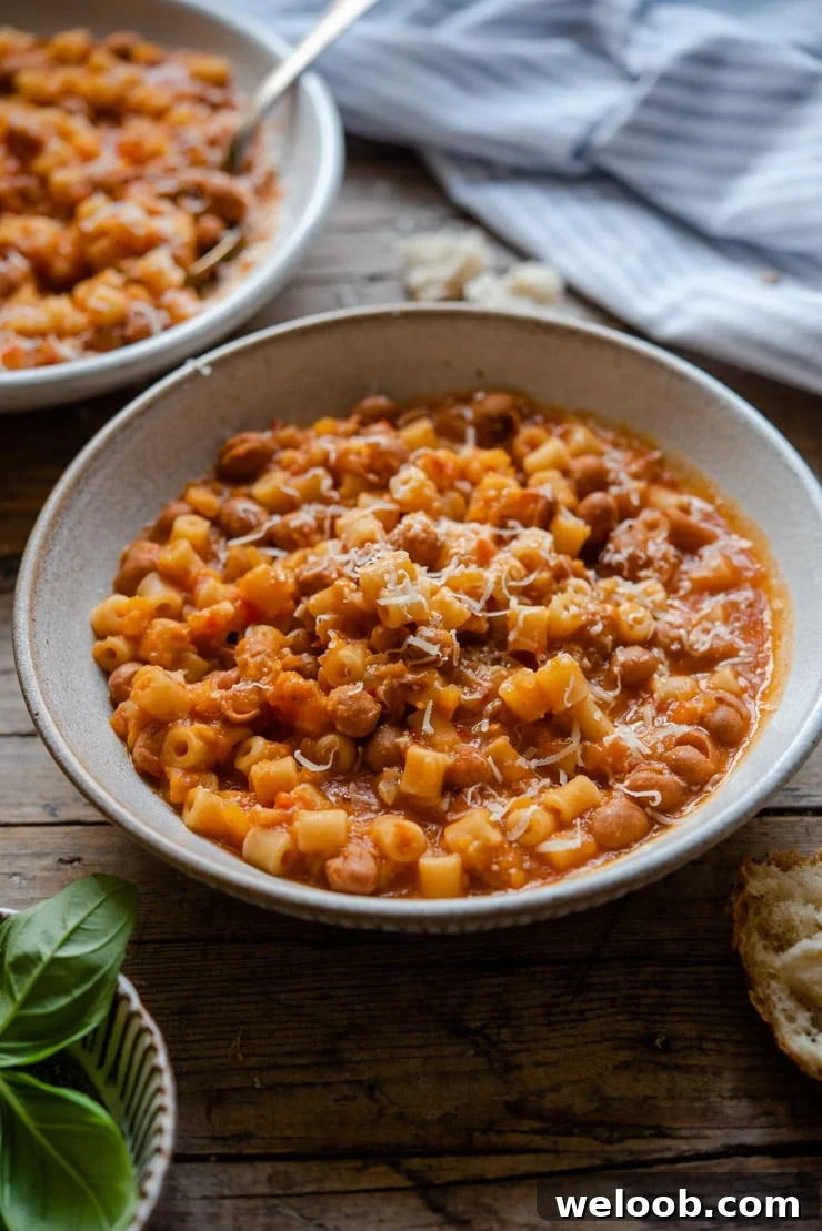 Pasta fagioli soup in a rustic bowl with crusty bread