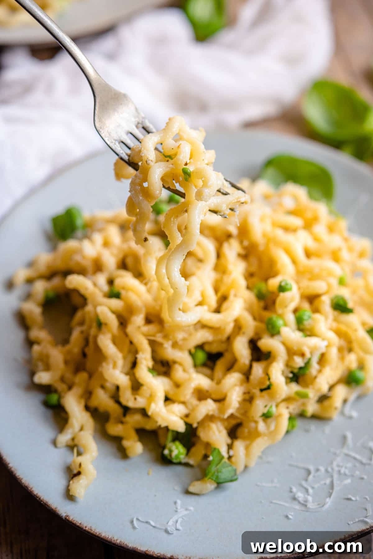 A close up of artichoke pasta on a fork