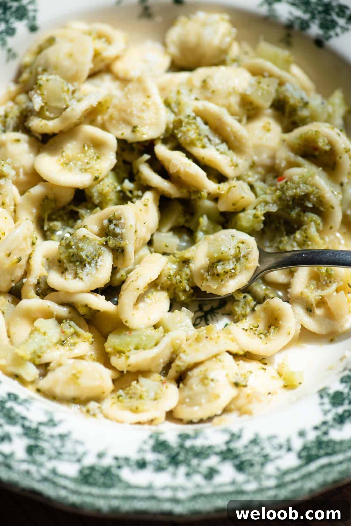 A close up of orecchiette in a bowl with broccoli.