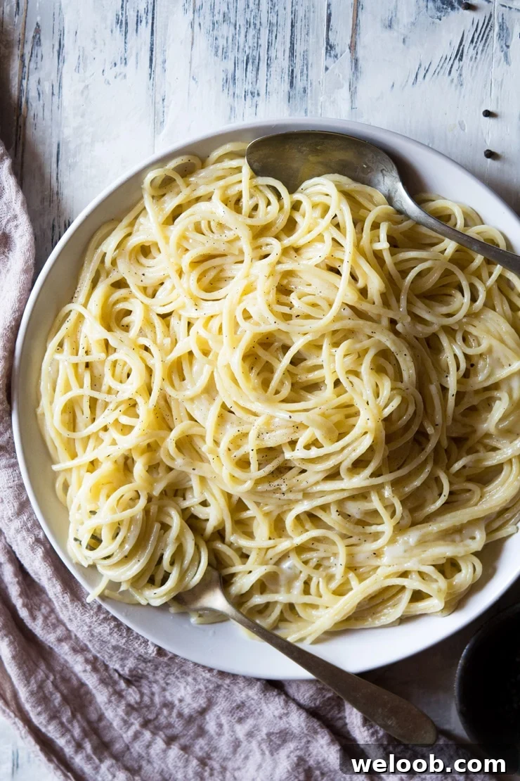 An overhead shot of cacio e pepe recipe in a plate with a fork