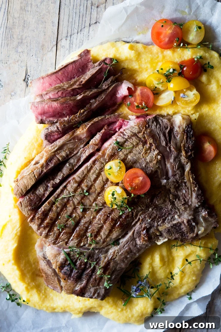 An overhead shot of a Florentine steak on a wooden surface with herbs
