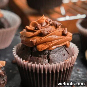 Zoom-in on a chocolate cupcake with chocolate frosting.