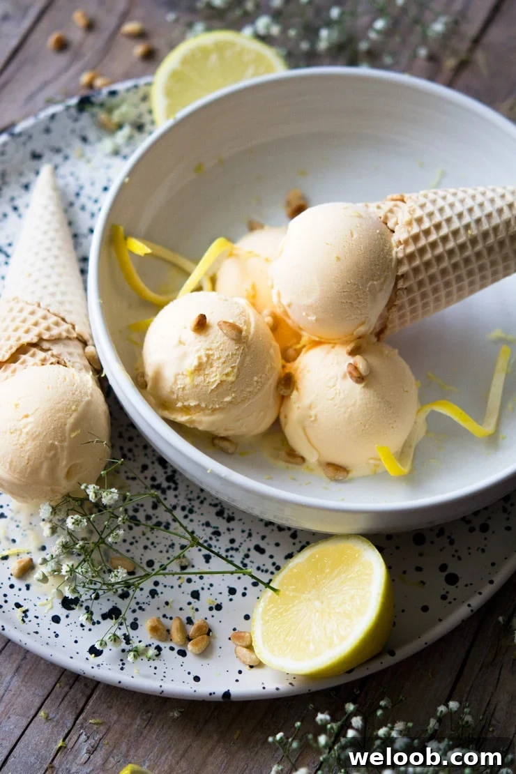 A side shot of scoops of ice cream in a bowl with a cone