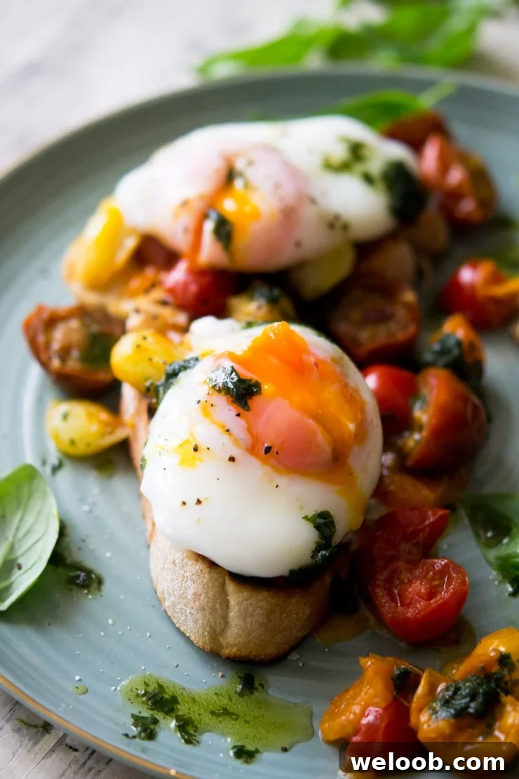 A close up of a oozing poached egg sitting on top of tomato breakfast crostini