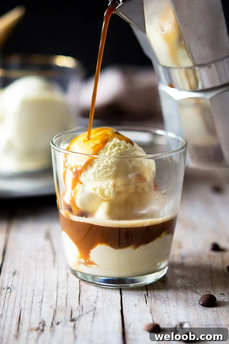 A photo of coffee getting poured over ice cream in a glass