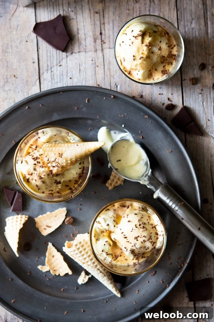 An overhead shot of two affogato desserts in glasses with ice cream cones broken up around them