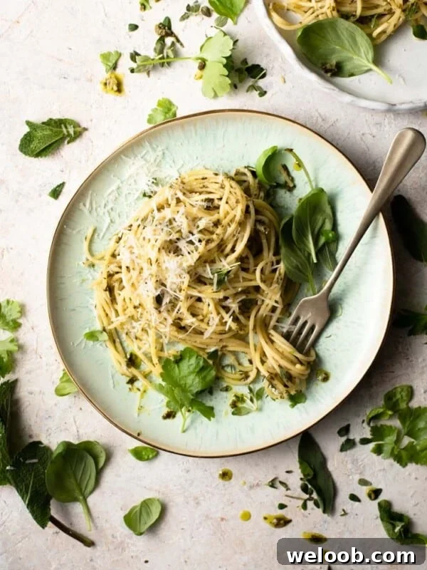 An overhead shot of herb garlic butter pasta sauce with spaghetti