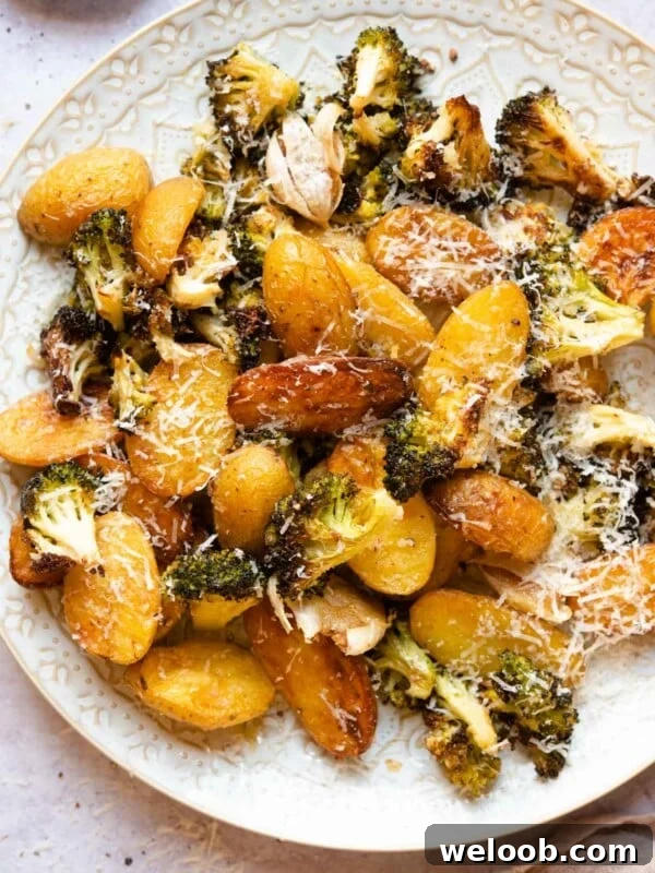 An overhead shot of roasted potatoes and broccoli on a plate