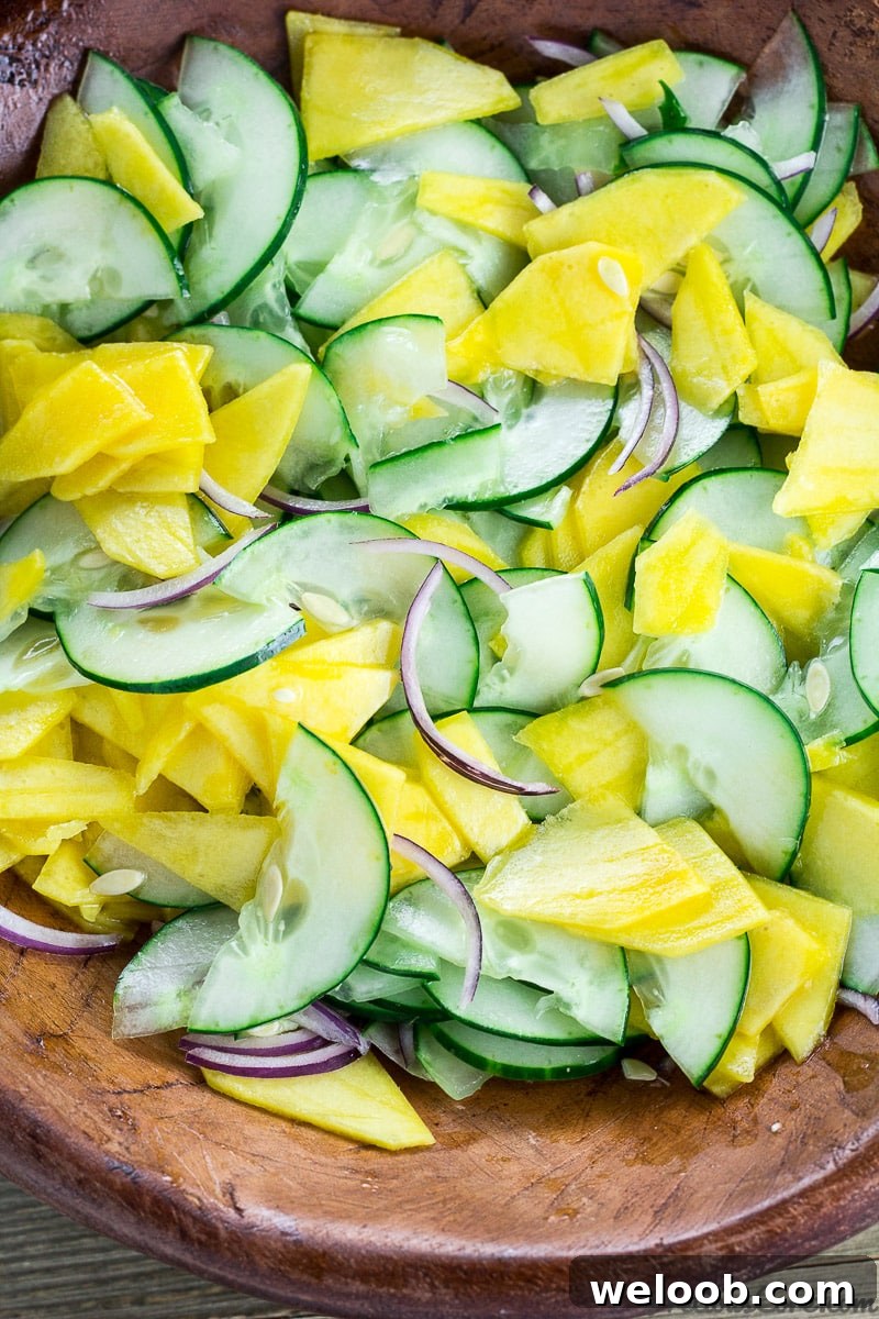 Cucumber Mango Salad tossed in a bowl