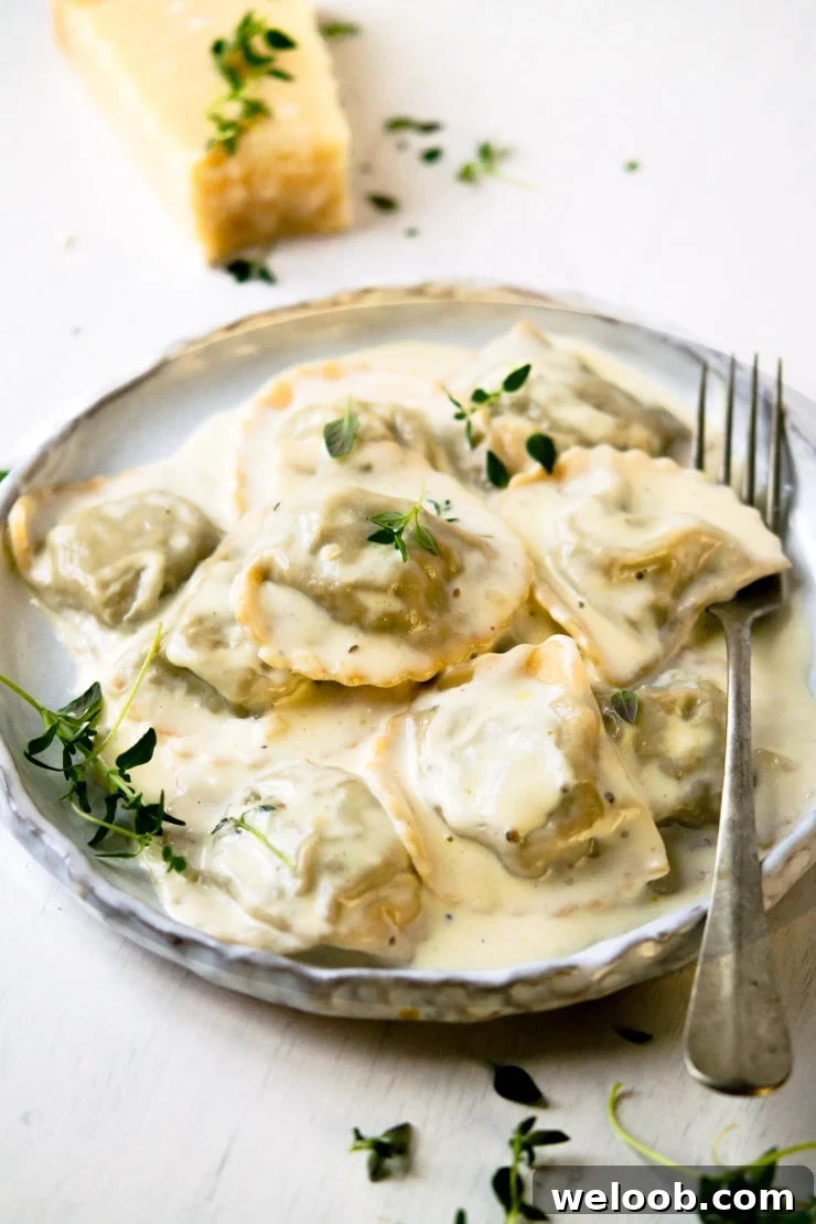 Close-up view of Stuffed Mushroom Ravioli with Parmesan Cheese on a Plate with a Fork