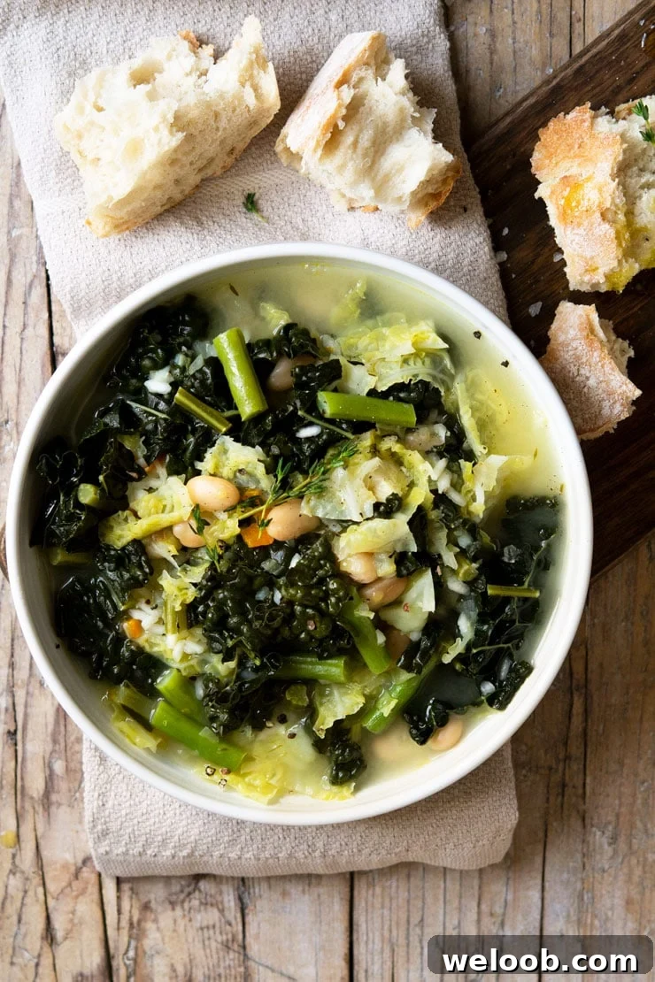 AN overhead shot of Tuscan minestrone soup on a wooden surface