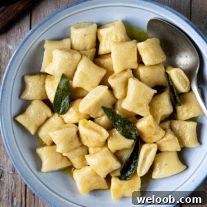 A square image of gnocchi with brown butter sage sauce