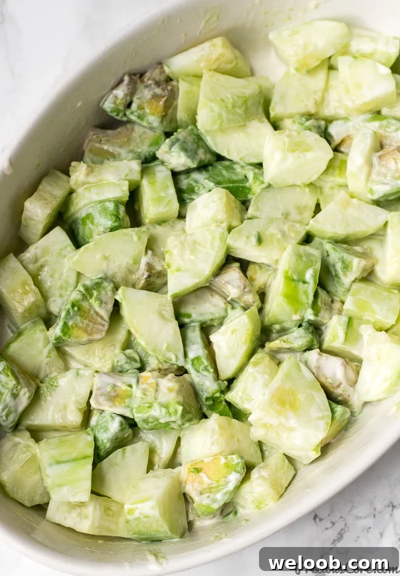 Cucumber Avocado Salad tossed with dressing