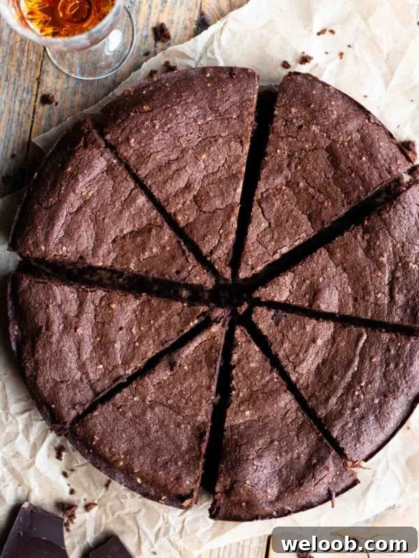 An overhead shot of an Italian flourless chocolate cake cut into slices.