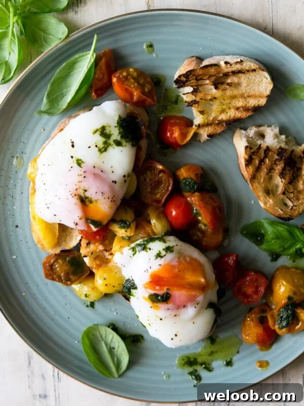 An overhead shot of sauted tomato breakfast crostini topped with poached eggs on a plate