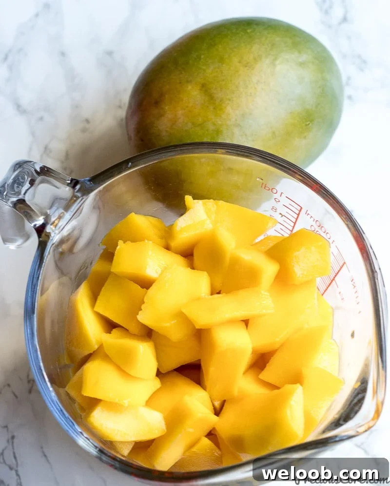 a cup of peeled mangoes for mango juice