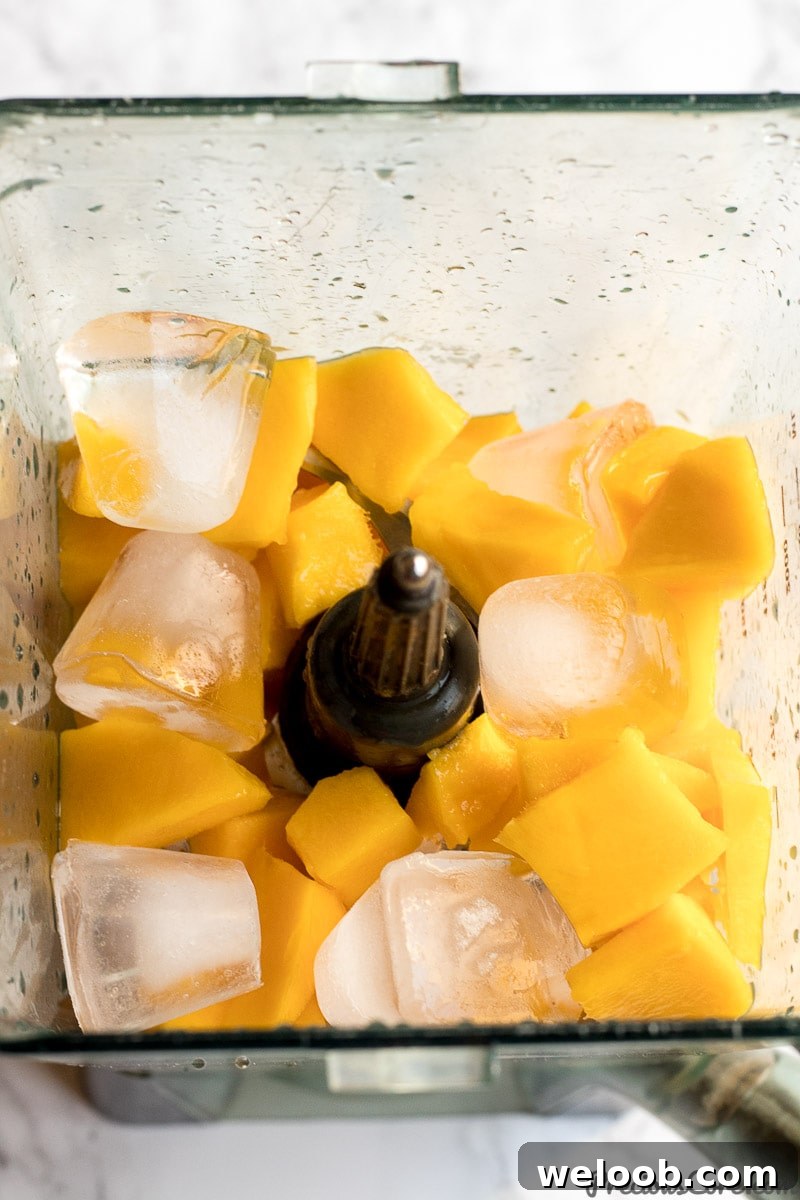 chopped mangoes in a blender for mango juice
