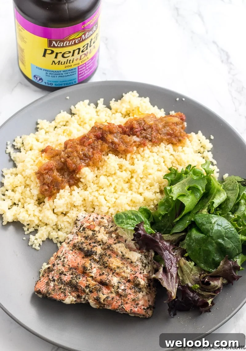 Healthy grilled salmon served with green veggies, couscous.