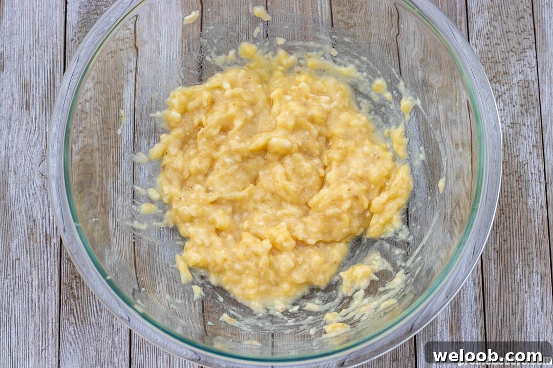 Mashed bananas in a mixing bowl.