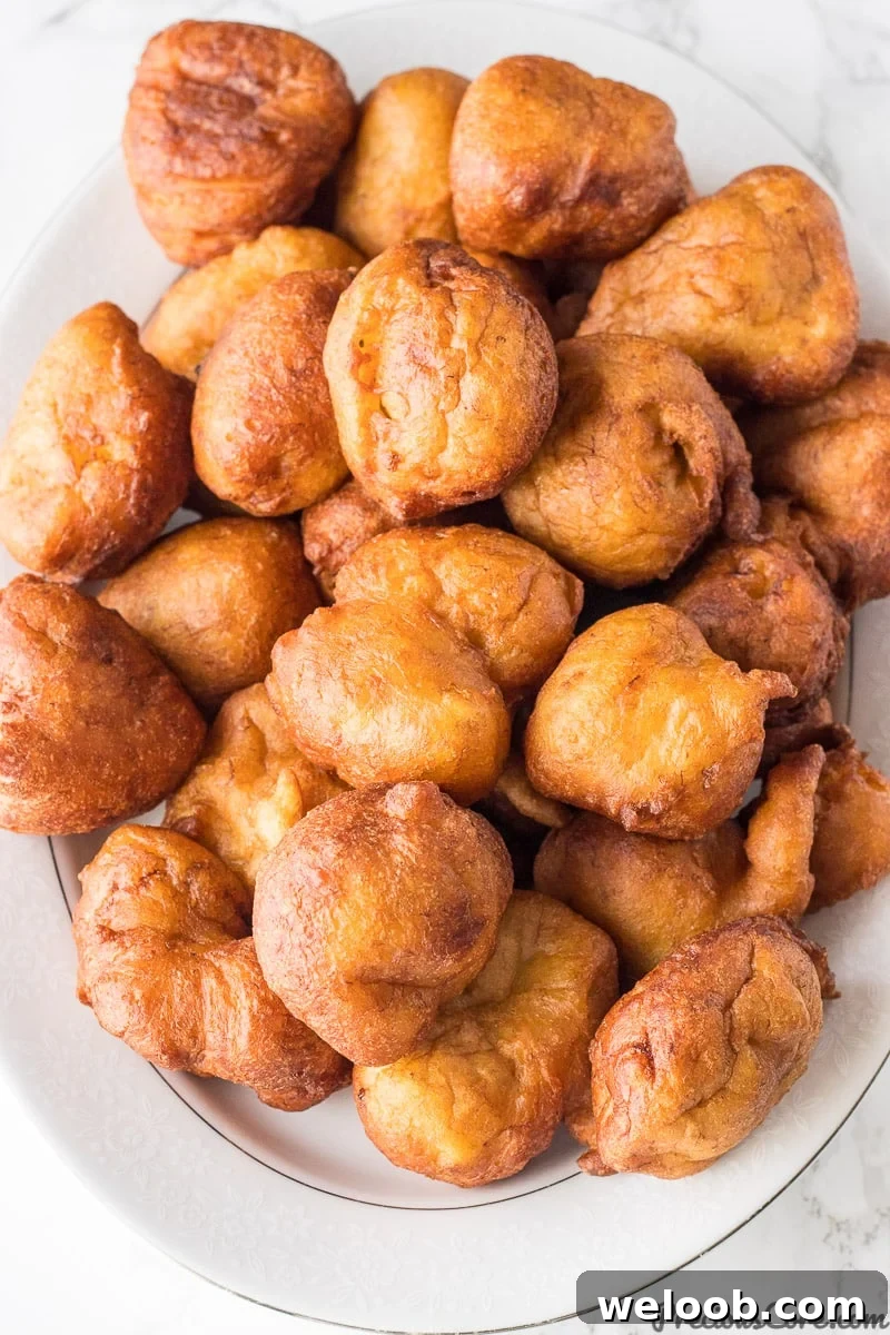Brown fritters on a serving platter.