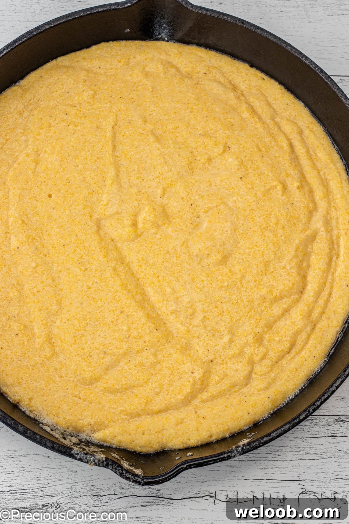 Cornbread batter in cast iron skillet.