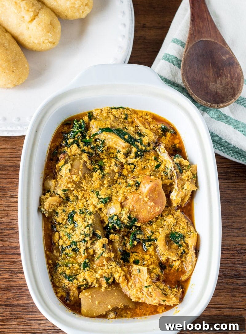 Egusi soup with meat in a white bowl.