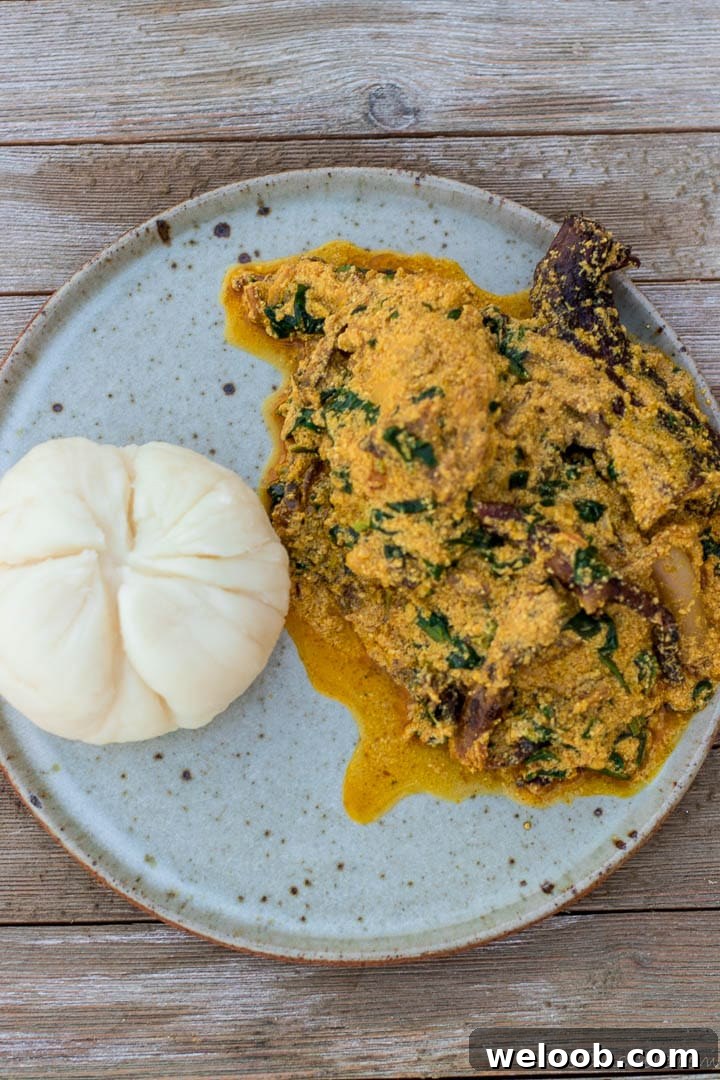 Egusi soup and pounded yam on a plate.
