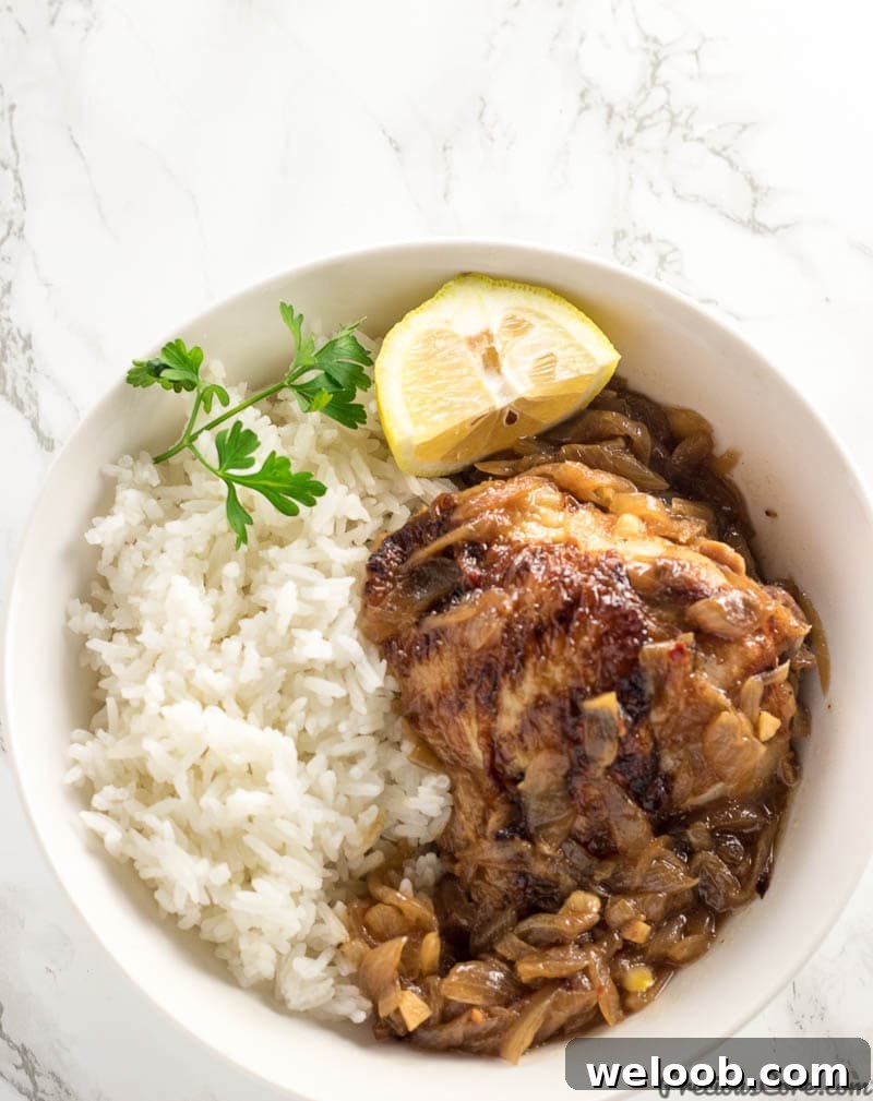 Poulet Yassa or Chicken Yassa served with rice.