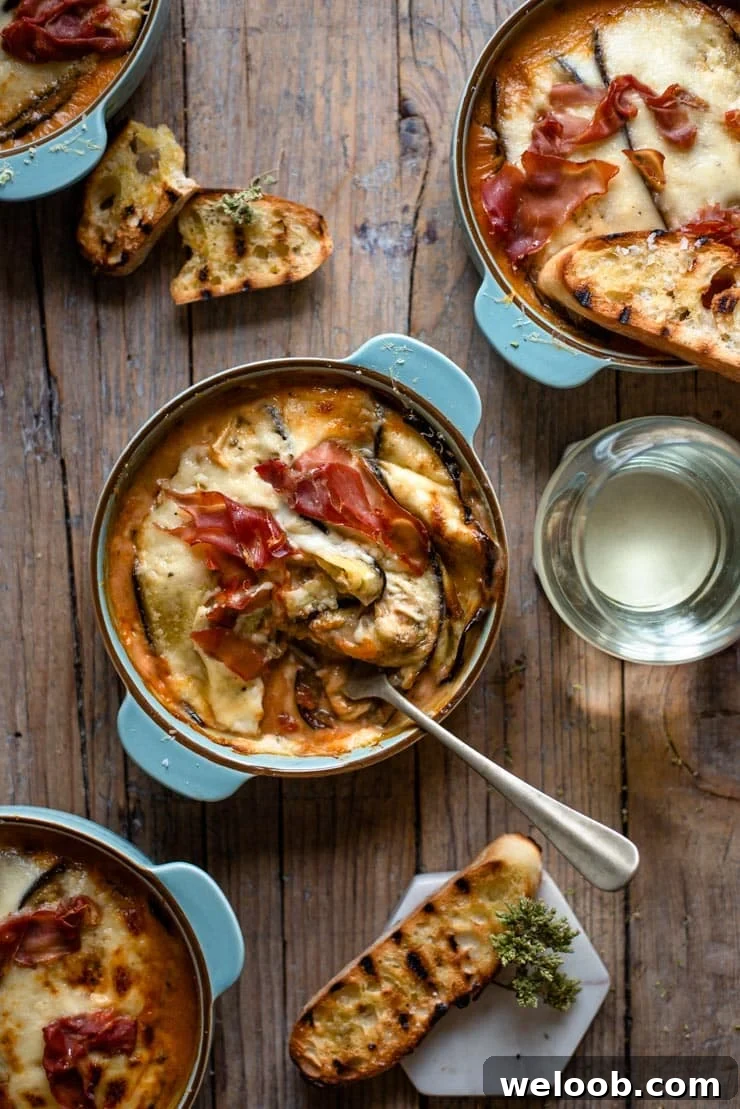 An overhead shot of eggplant lasagna in a blue dish with a fork