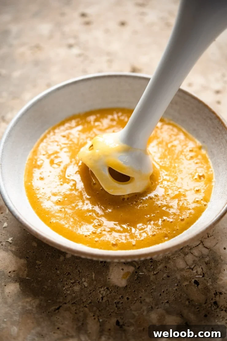 A close up of making peach puree to make a peach bellini cocktail
