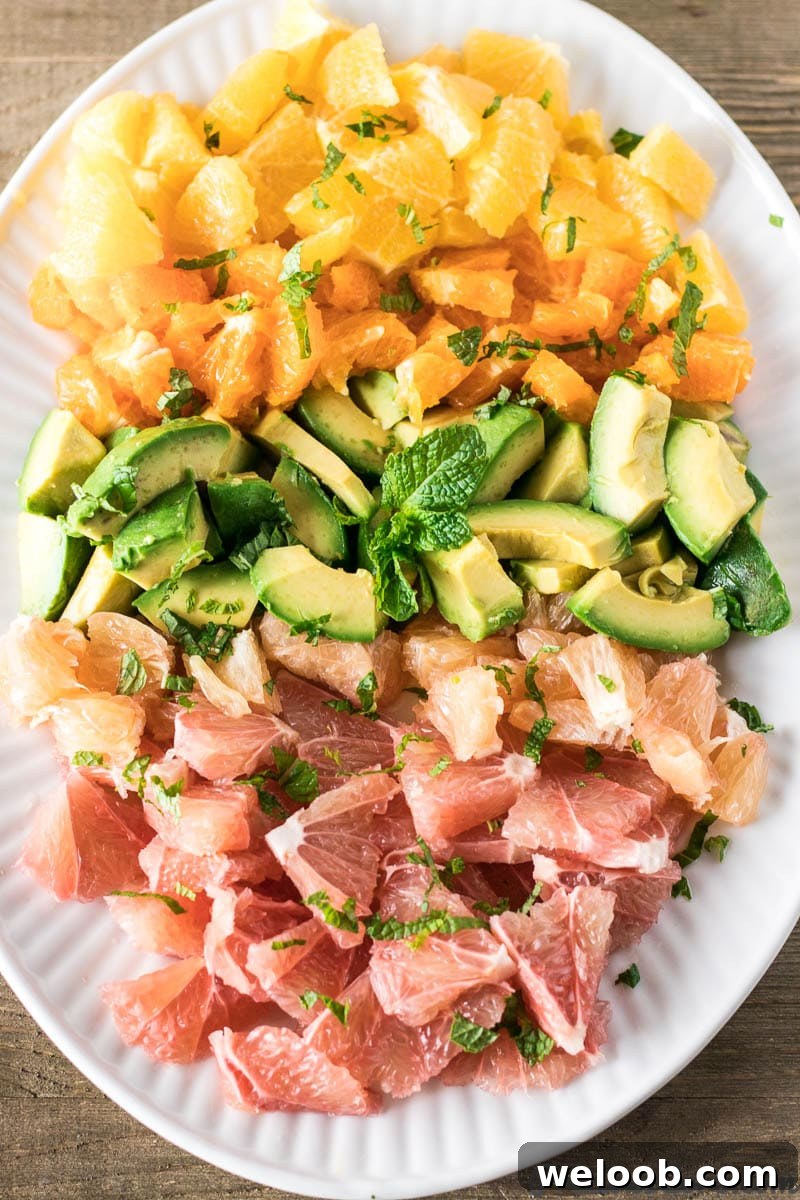 Citrus Salad with Avocado on a white plate.