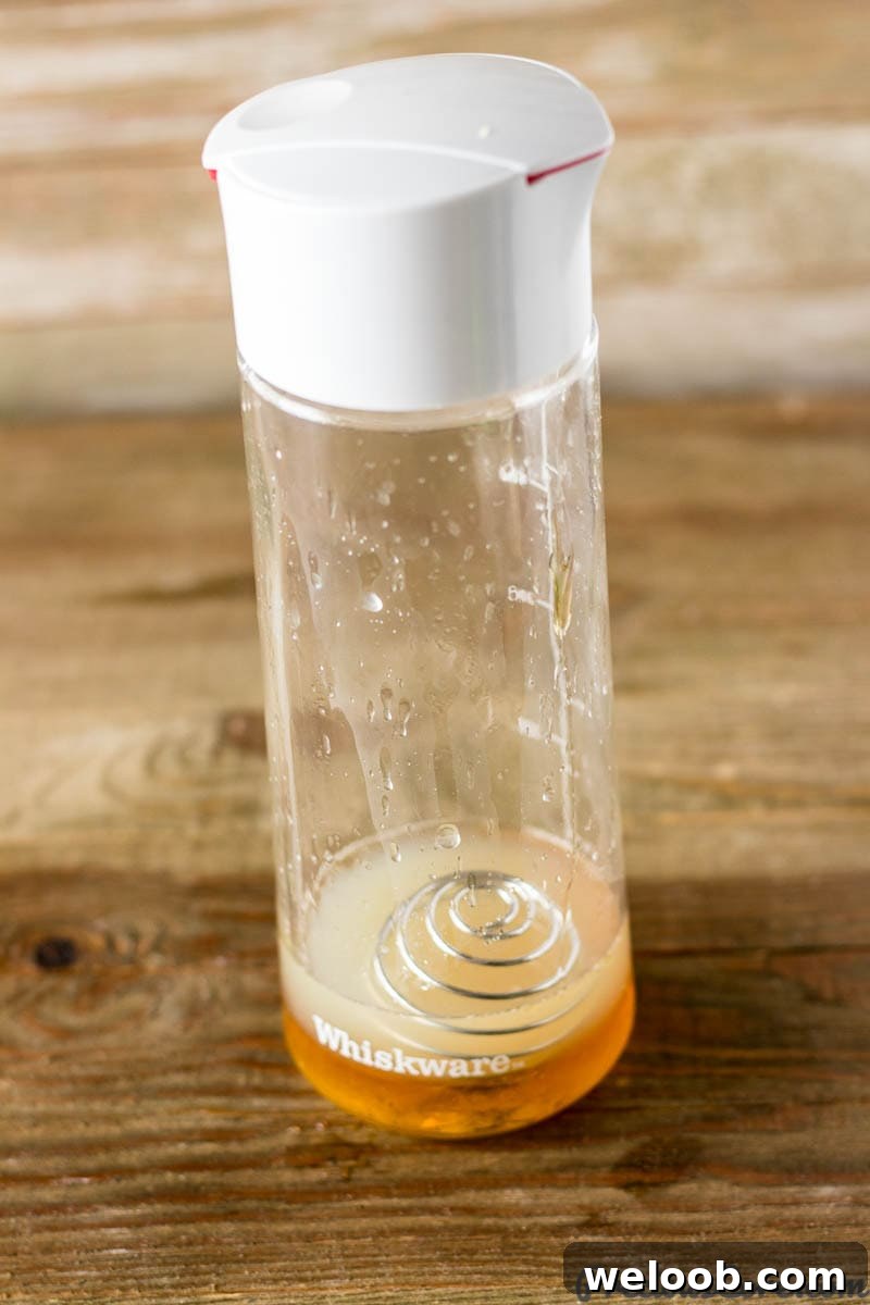 Whiskware dressing shaker filled with a citrus honey dressing.