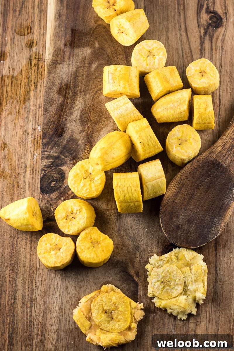 Wooden spoon with flattened plantains.