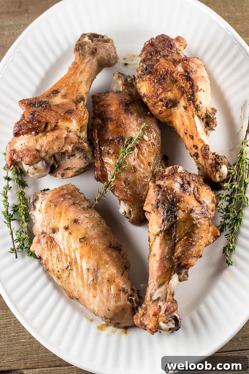 Freshly baked turkey wings on a white platter.