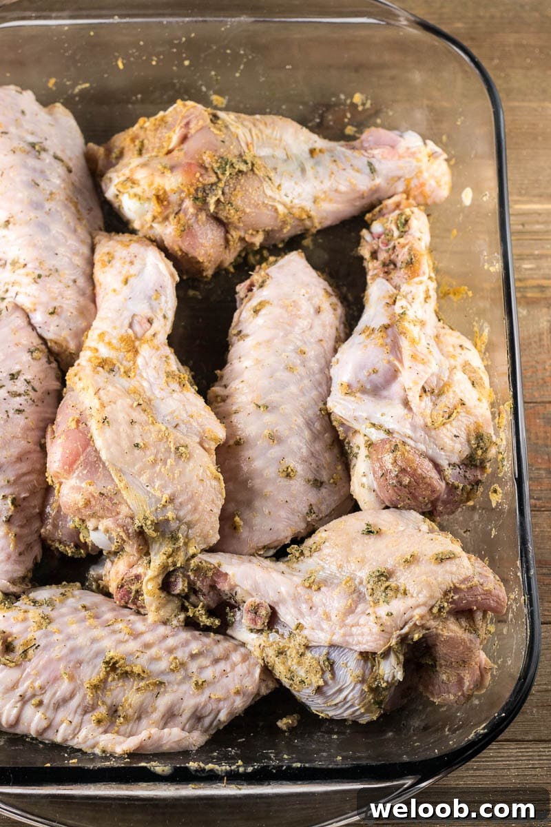 Seasoned turkey wings in a baking dish.