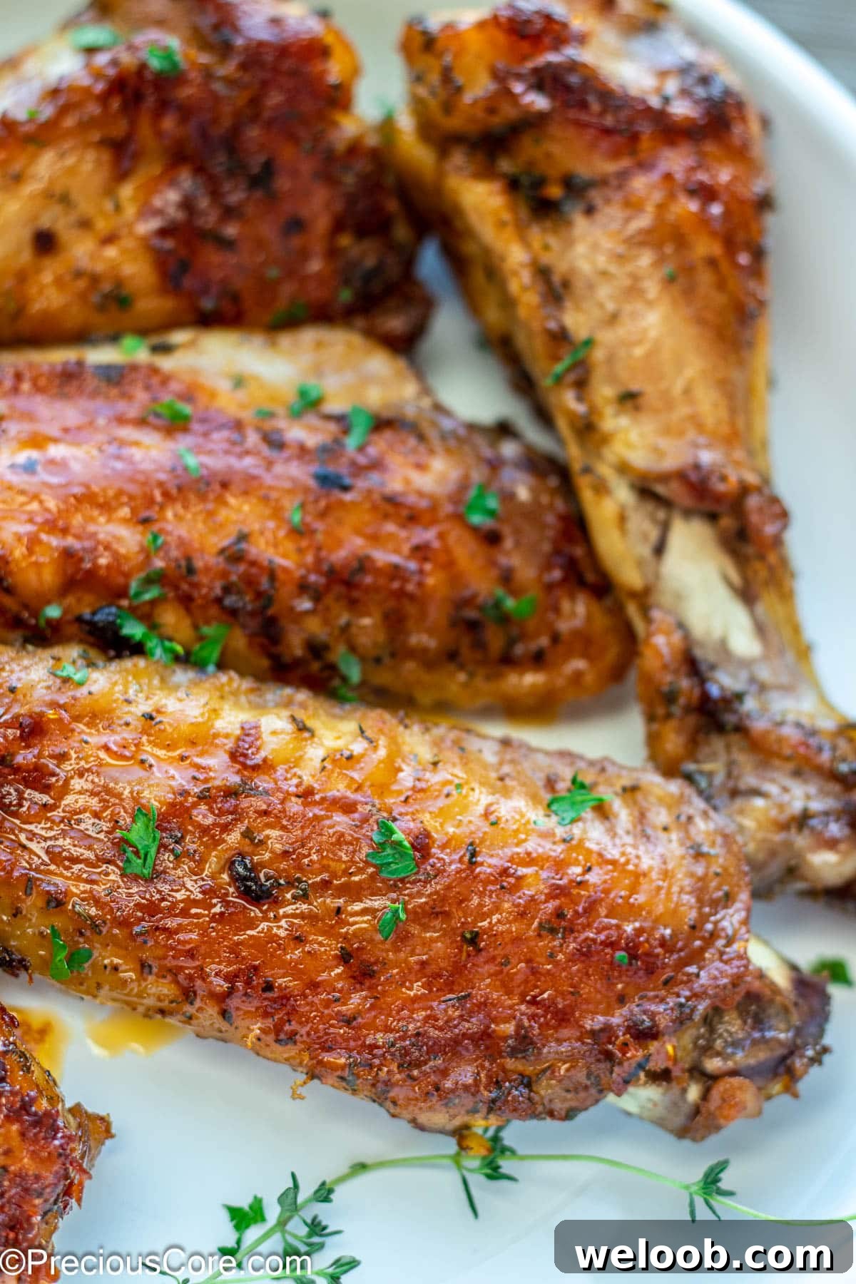 Brown cooked turkey wings garnished with minced parsley.