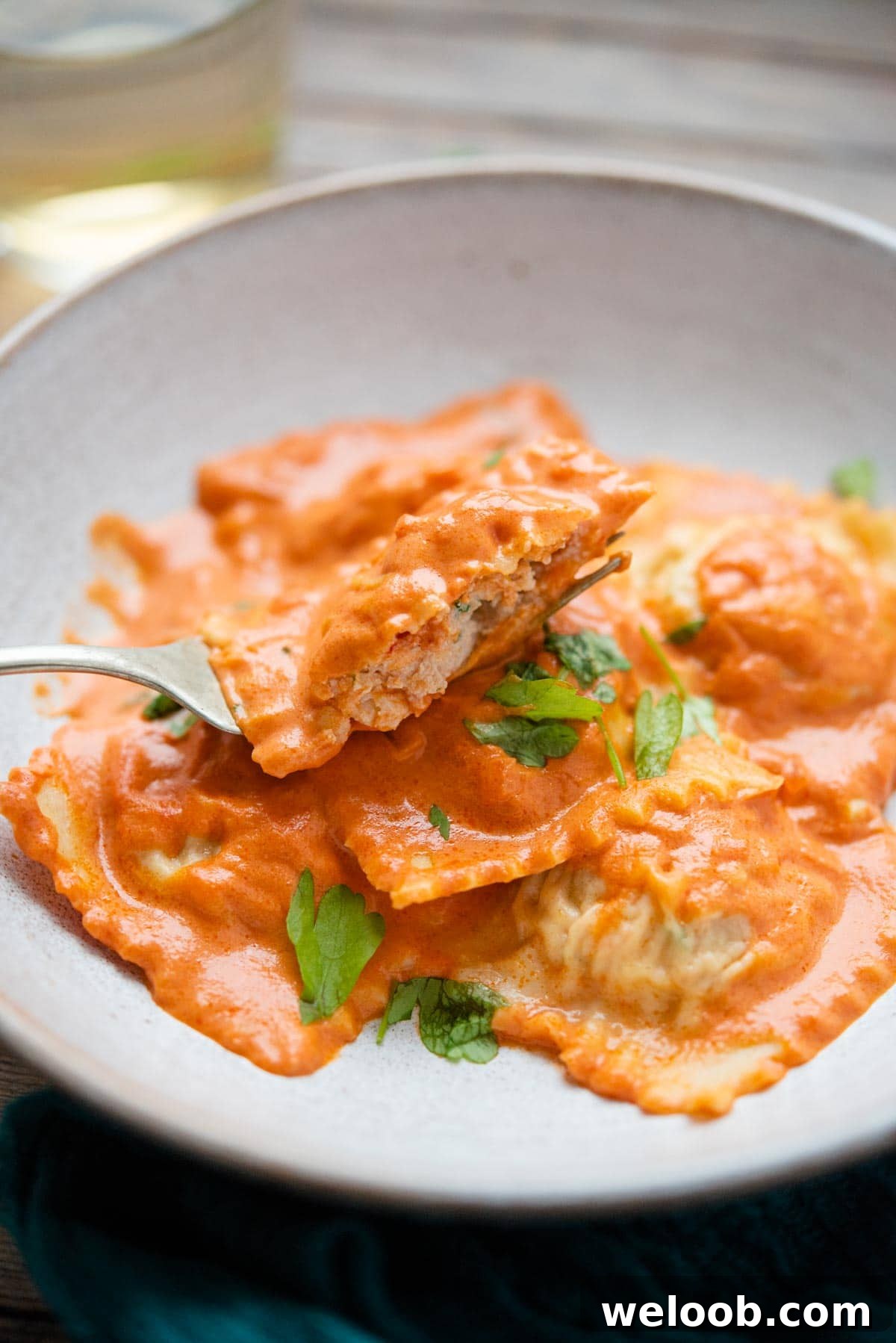 A close up of ravioli cut in half on a fork