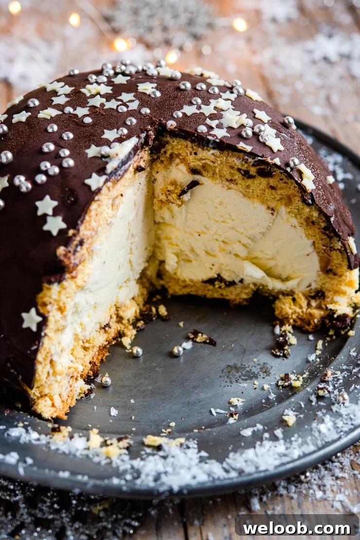A close up of a panettone bomb Christmas ice cream cake with a slice cut out