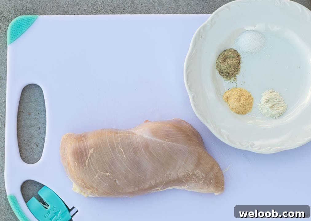Chicken on cutting board, seasonings on plate