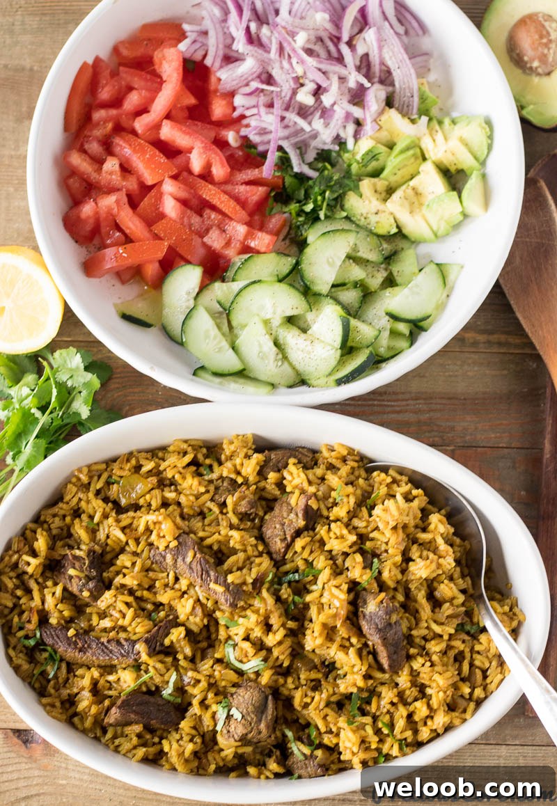 Bowl of Beef Pilau next to a bowl of vegetables.