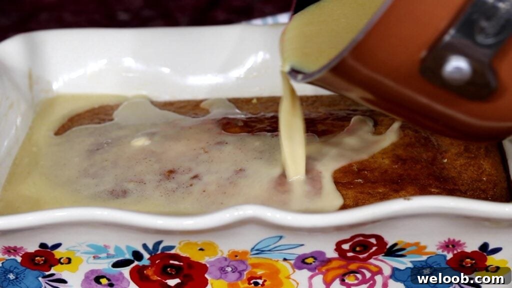 pouring butter sauce from saucepan onto cake