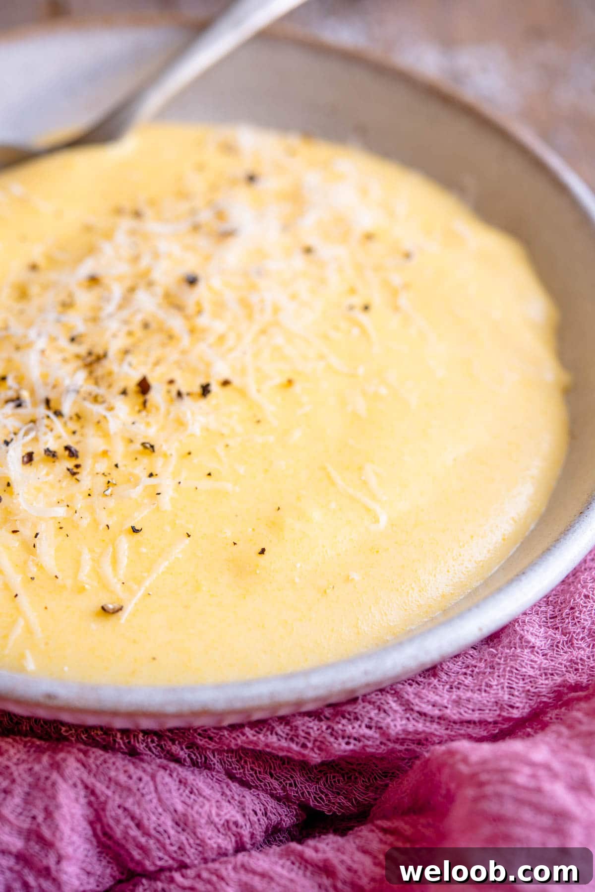 A side shot of creamy polenta in a bowl