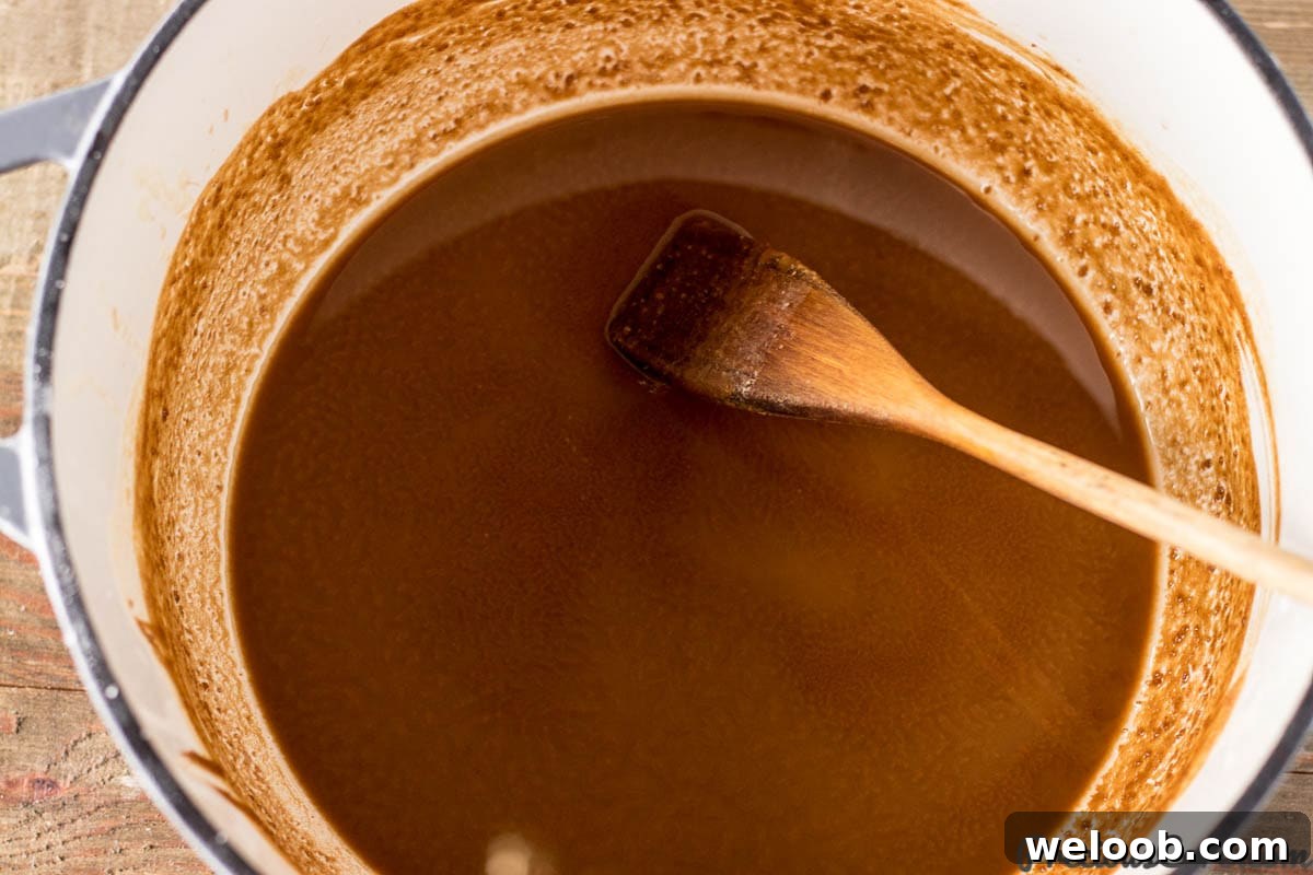 Wooden spoon in a pot of roux.