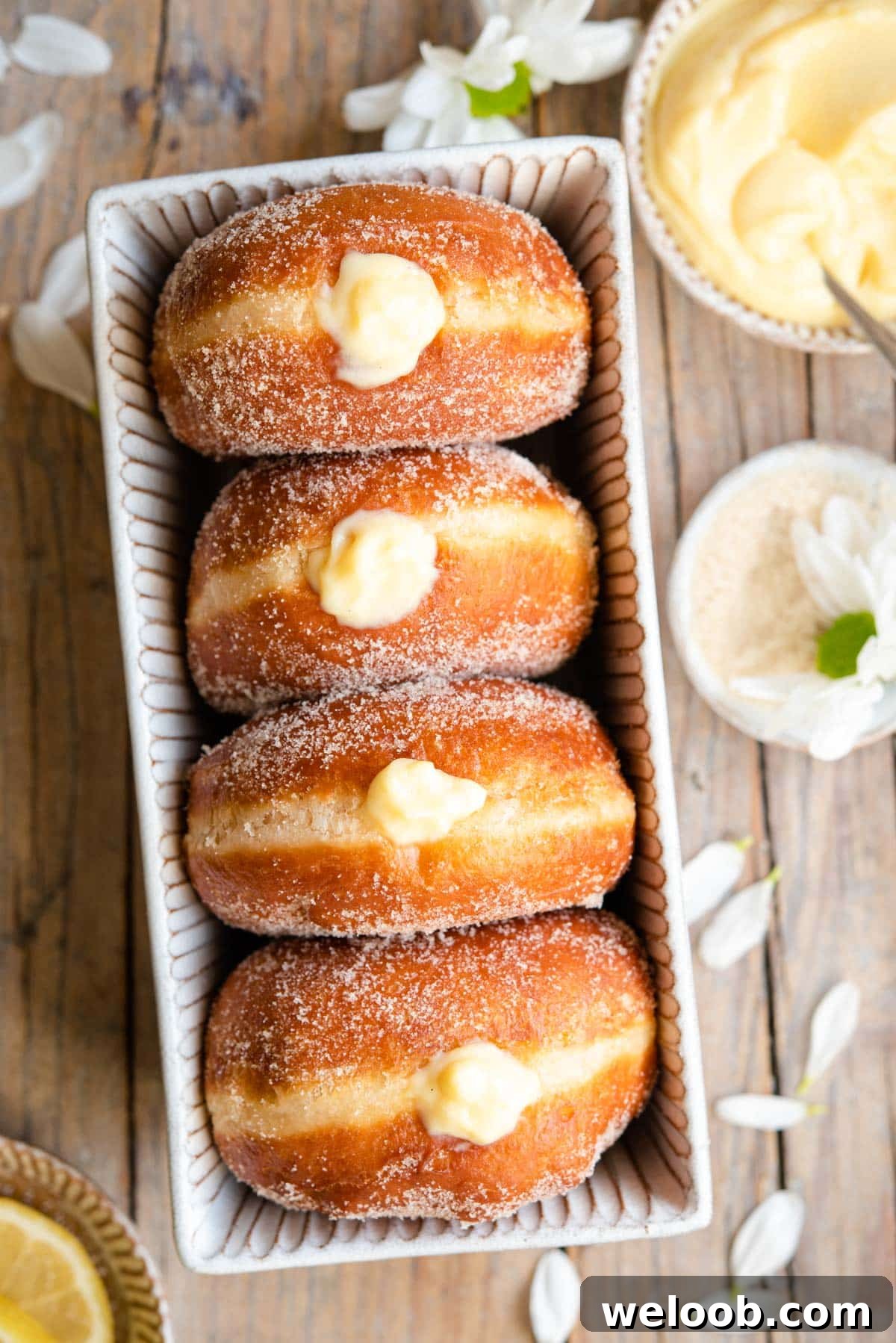 An overhead shot of bomboloni doughnuts in a rustic dish